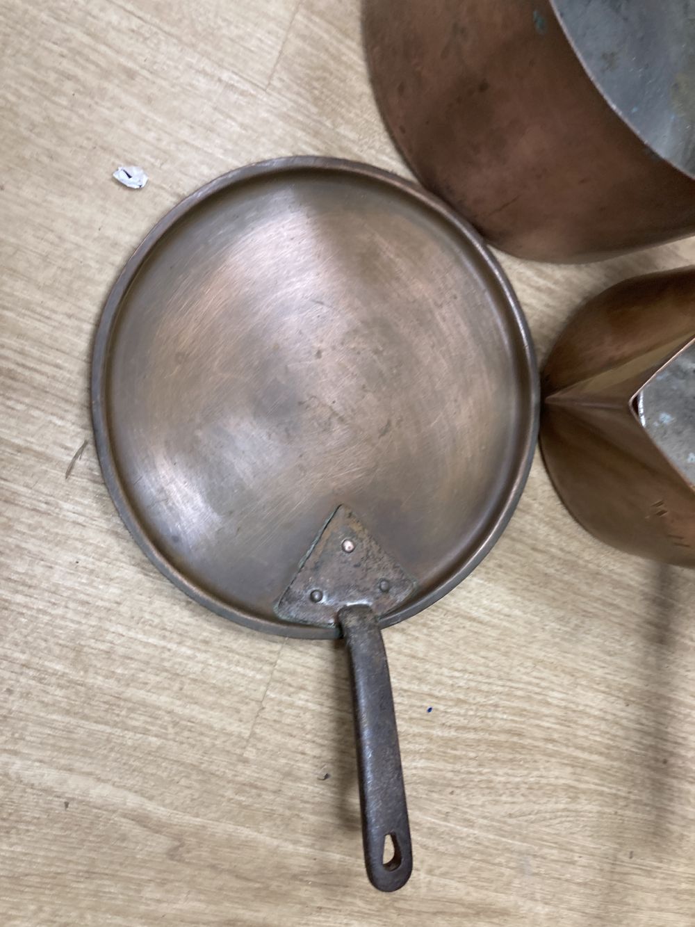 Three 19th century copper pans, one with lid, middle saucepan 27cm diameter